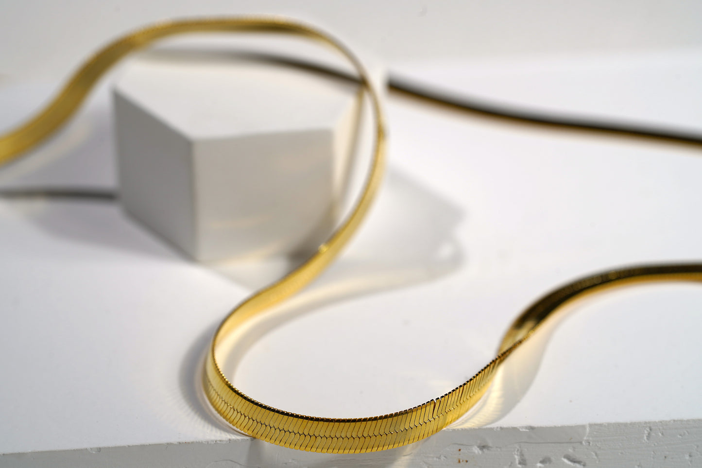 "Elevate your look with our Snake Herringbone Style Chain. Available in gold-plated sterling silver or 925 sterling silver, and in 18-inch or 20-inch lengths. Italian craftsmanship, hypoallergenic. Shop now!"