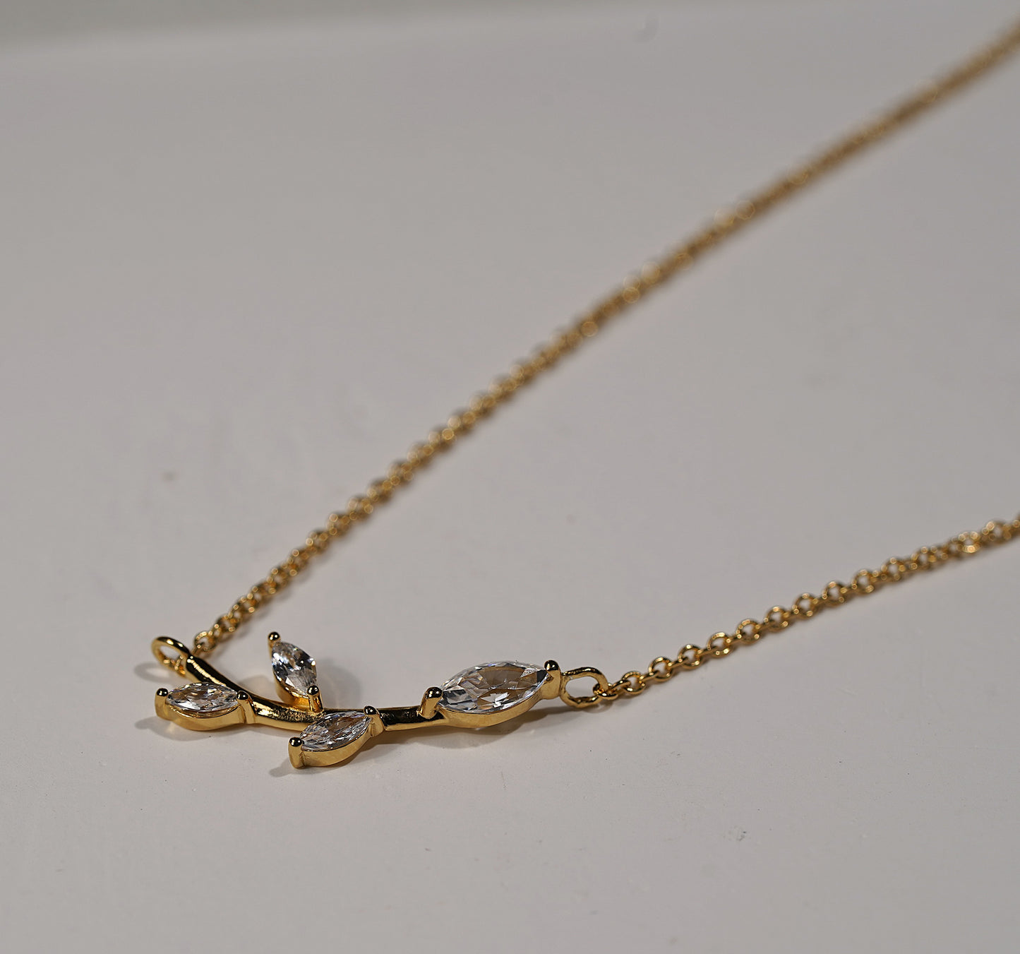 Gold plated branch and leaf necklace with CZ adornment