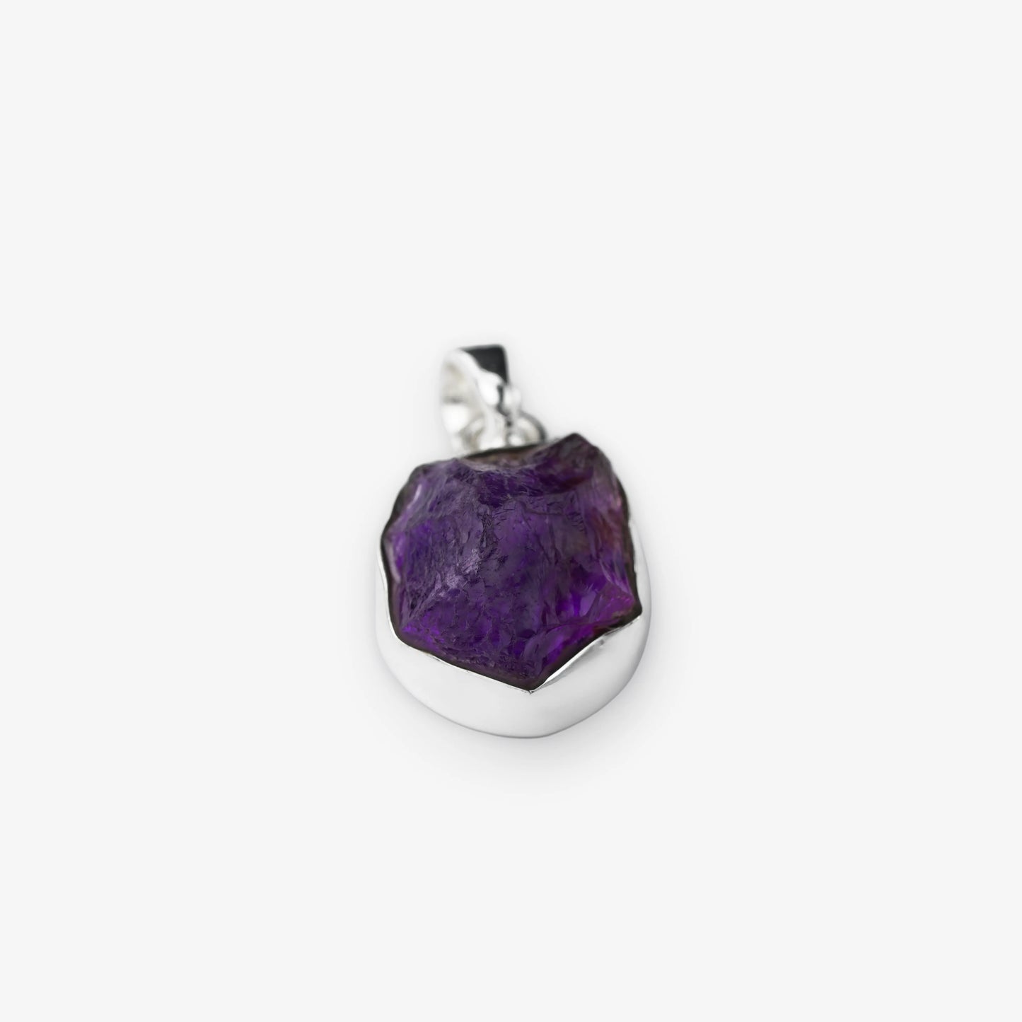 A raw amethyst pendant with a polished silver bezel and bail, shown on a clean white background.