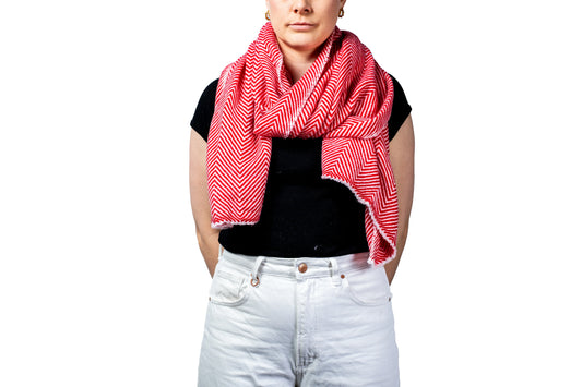 Person wearing a red and white patterned pashmina scarf on a white background- GRIHA