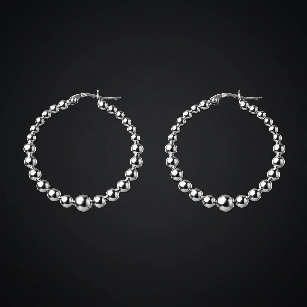 beaded sterling silver hoop earring on a black background