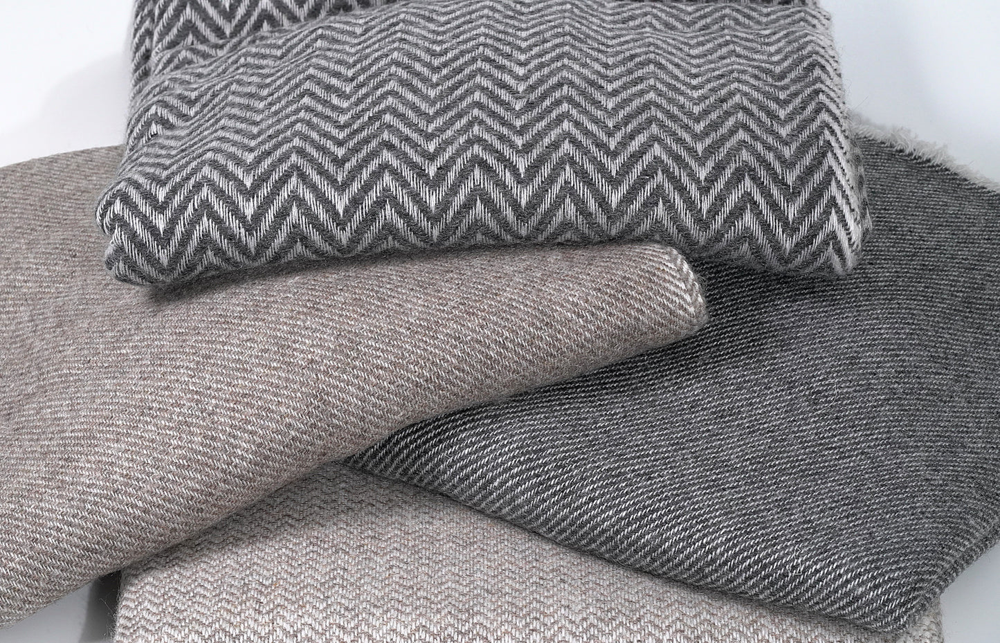 Stack of Pashminas Together Showcasing Various Textures, Weaves and Colours