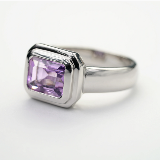Sterling silver amethyst gemstone ring with a rectangular-cut purple stone in a modern bezel setting