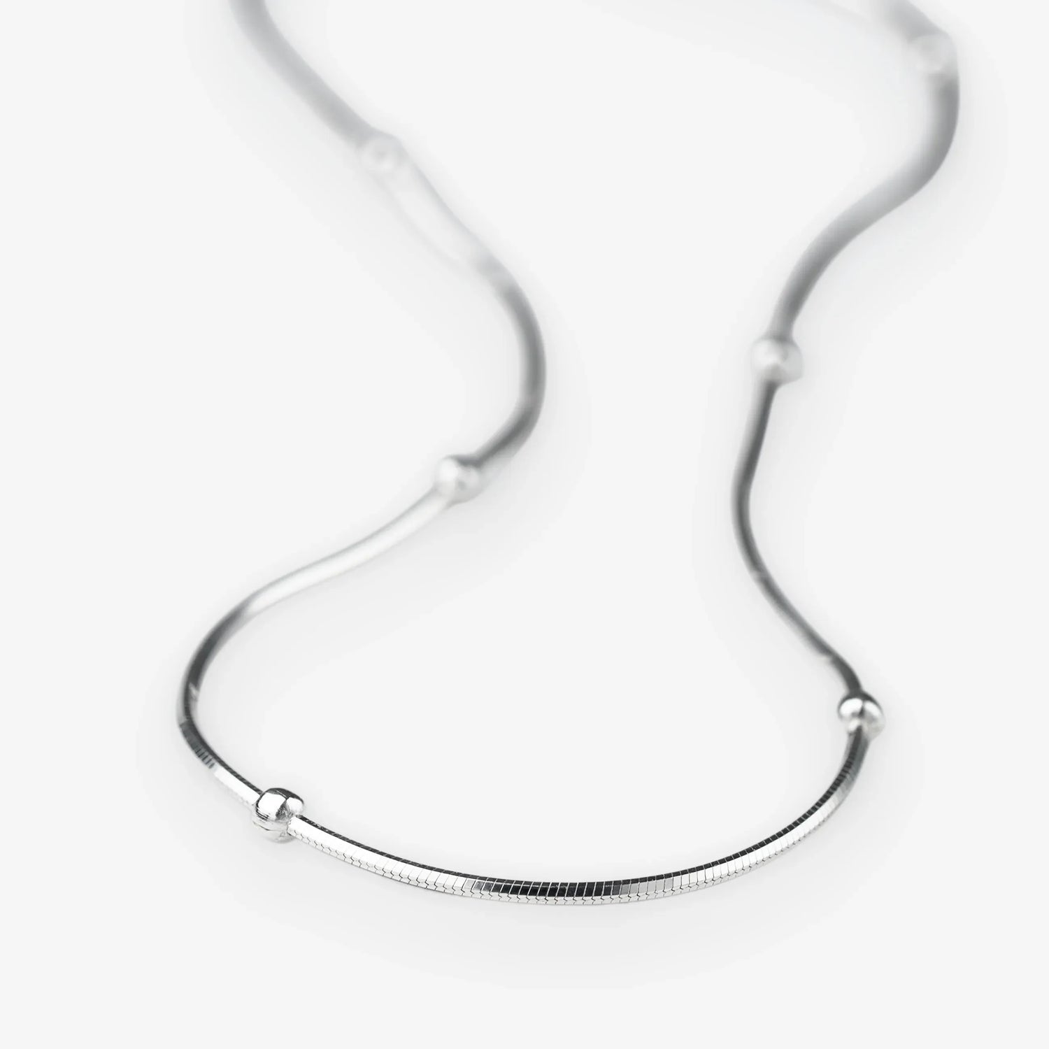 Silver chain. Knitted chain.