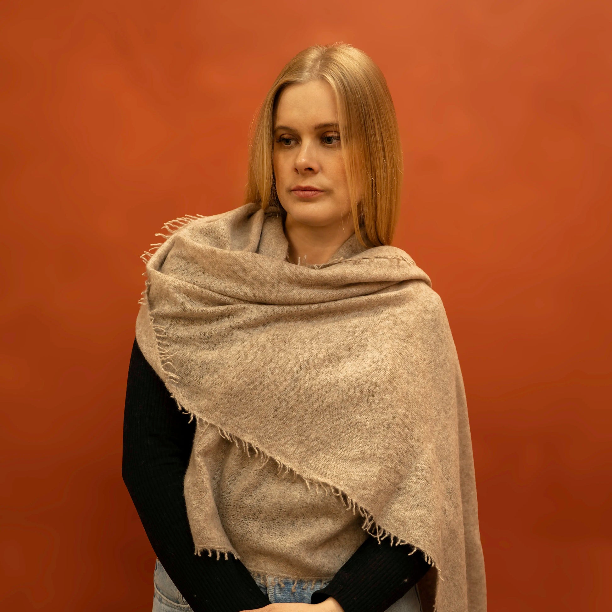 Woman wearing oversized fawn pure cashmere woven shawl draped over shoulders — Griha Himalayan cashmere