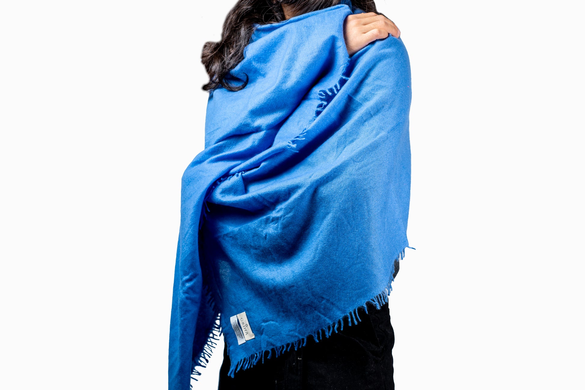 Person wearing a blue cashmere scarf with a white background GRIHA