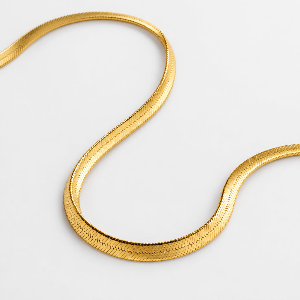 "Elevate your look with our Snake Herringbone Style Chain. Available in gold-plated sterling silver or 925 sterling silver, and in 18-inch or 20-inch lengths. Italian craftsmanship, hypoallergenic. Shop now!"