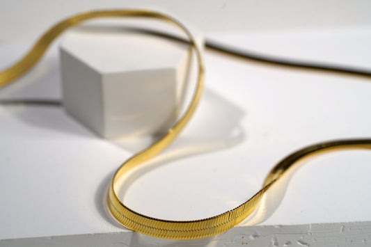 "Elevate your look with our Snake Herringbone Style Chain. Available in gold-plated sterling silver or 925 sterling silver, and in 18-inch or 20-inch lengths. Italian craftsmanship, hypoallergenic. Shop now!"