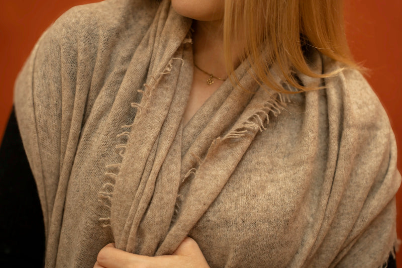 Close-up of fawn pure woven cashmere shawl showing open weave texture and fringe trim — Griha Himalayan cashmere