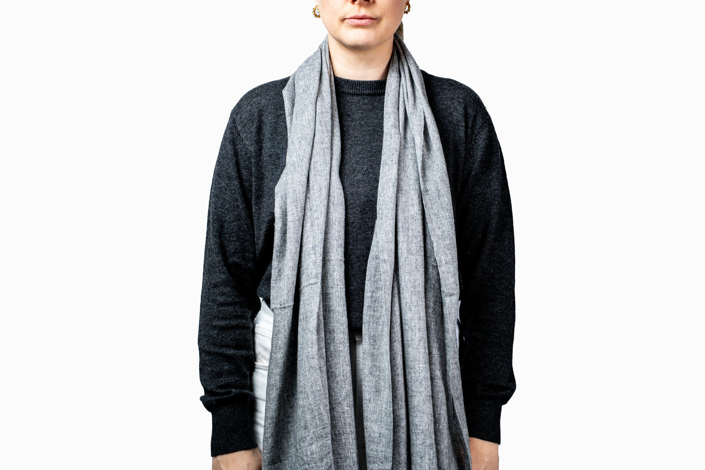 Person wearing a grey pashmina scarf on a white background- GRIHA