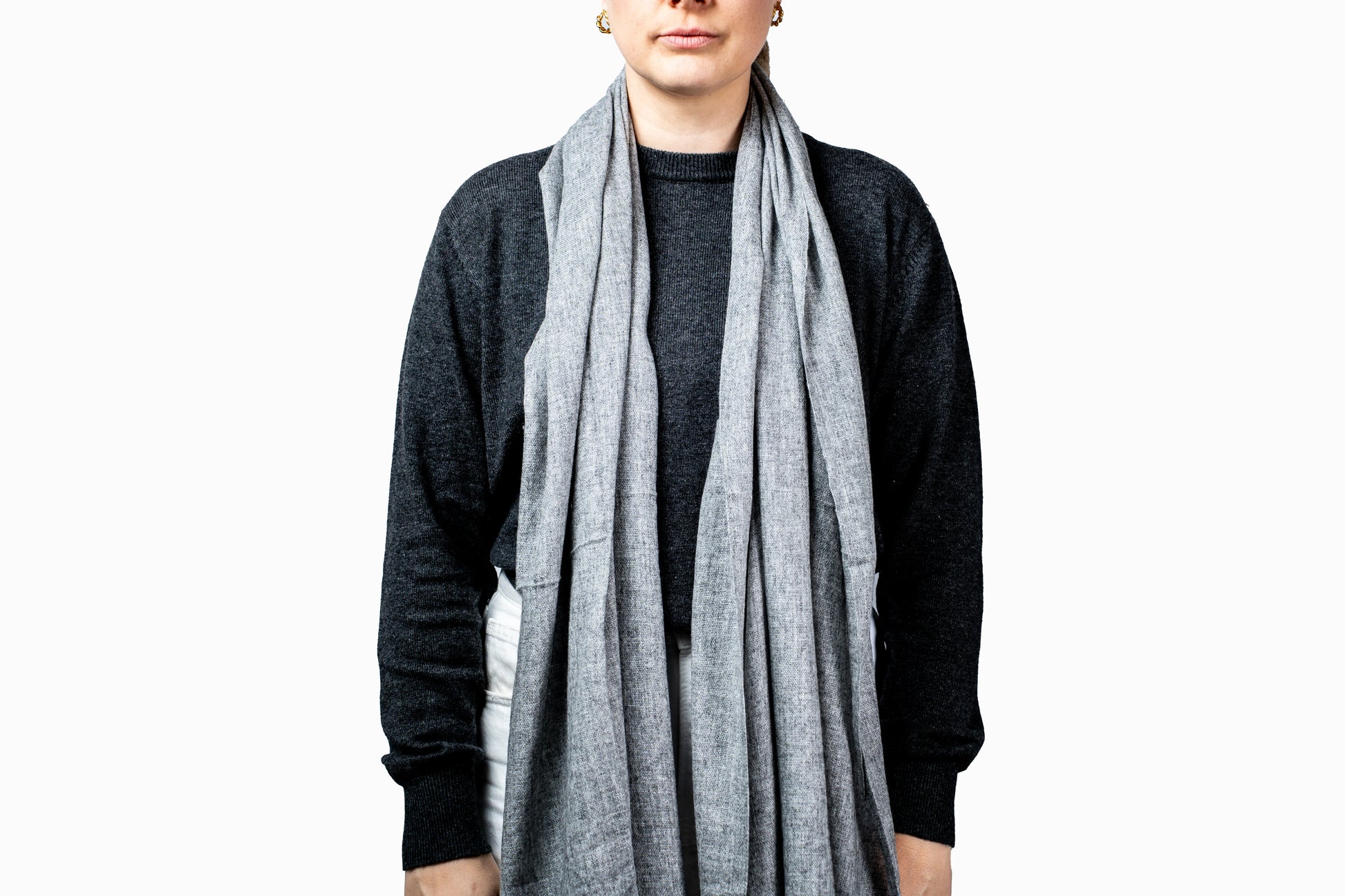 Person wearing a grey pashmina scarf on a white background- GRIHA