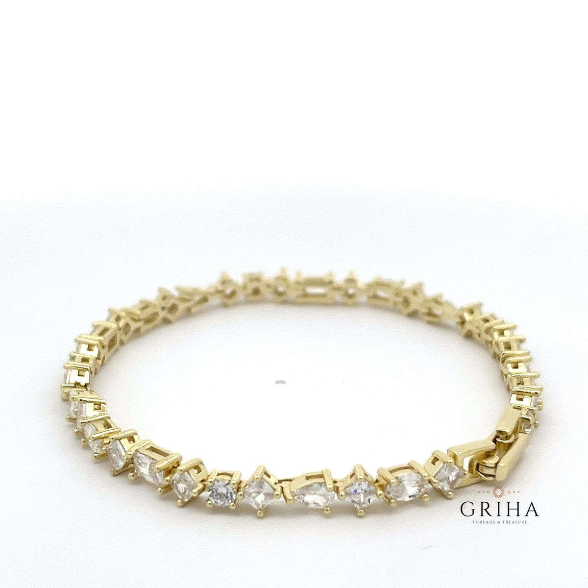 Multi shaped gold plated tennis bracelet prong set