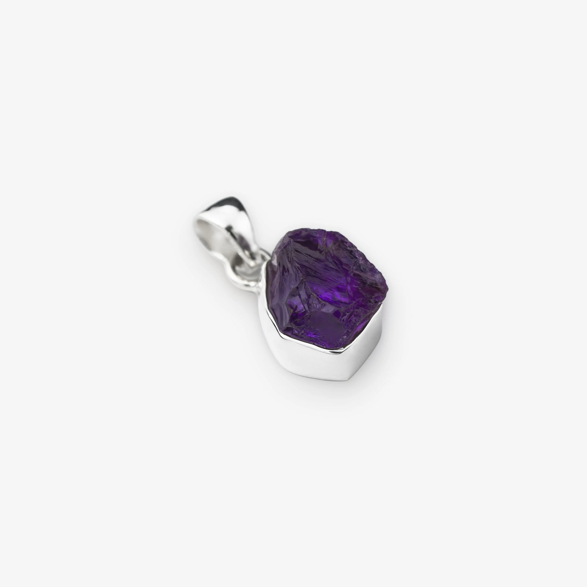 Natural Amethyst cut stone pendant set in sterling silver on white background