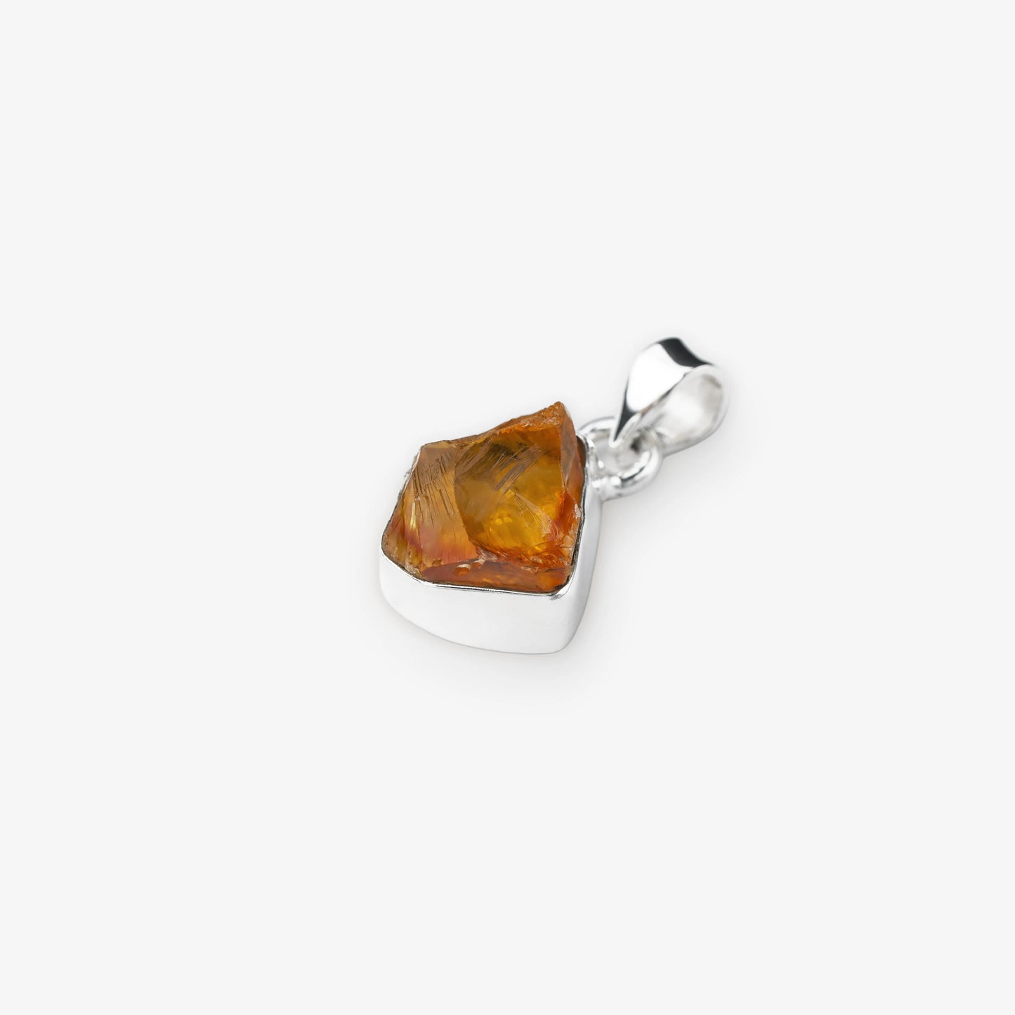 A polished silver pendant featuring a raw, faceted citrine gemstone, shown on a clean light gray background.