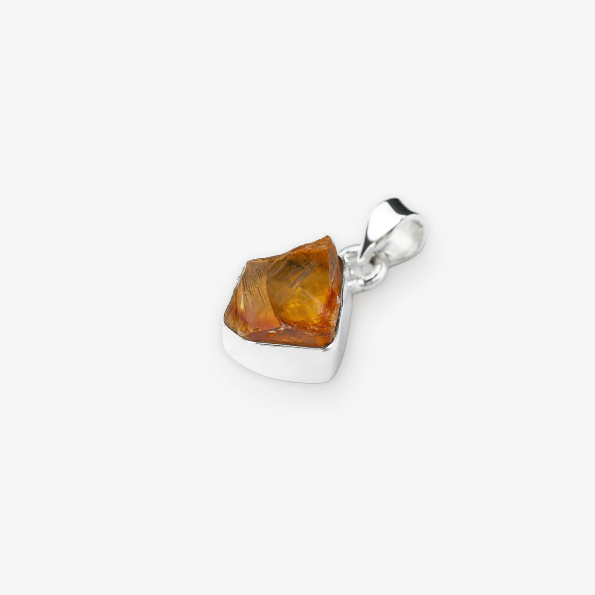 A polished silver pendant featuring a raw, faceted citrine gemstone, shown on a clean light gray background.
