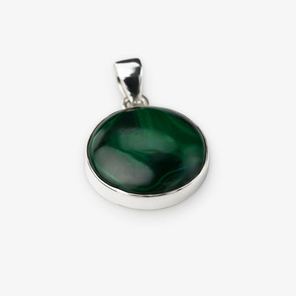 A round silver pendant featuring a polished dark green malachite stone with natural swirling patterns, set in a silver bezel with a silver bail, shown on a light gray background.