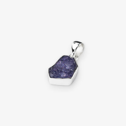 Tanzanite gemstone pendant natural cut stone set in sterling silver on white background