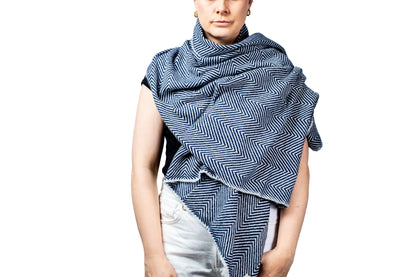 Person wearing a blue and white patterned scarf on a white background