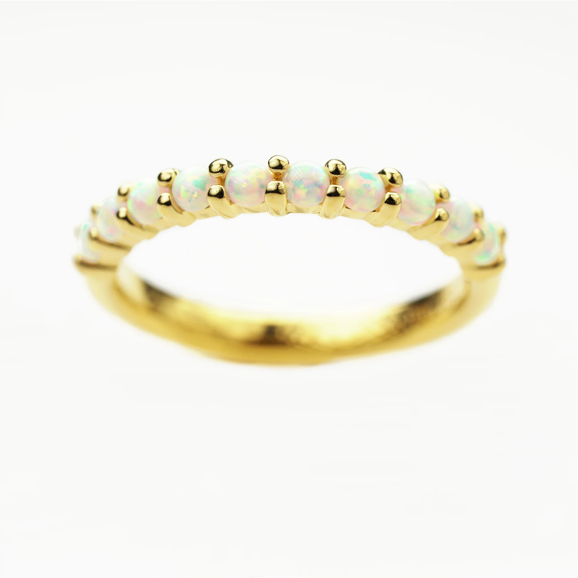 Gold plated sterling silver ring with opal stones on a white background