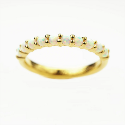Gold plated sterling silver ring with opal stones on a white background