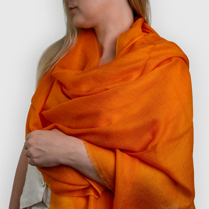 pashmina shawl scarf bright orange draped on model shoulder