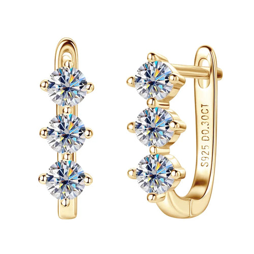 Gold hoop earrings with clear moissanite gemstones on a white background