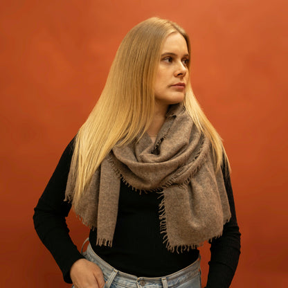  Woman wearing oversized taupe brown woven cashmere shawl wrapped around neck — Griha pure Himalayan cashmere