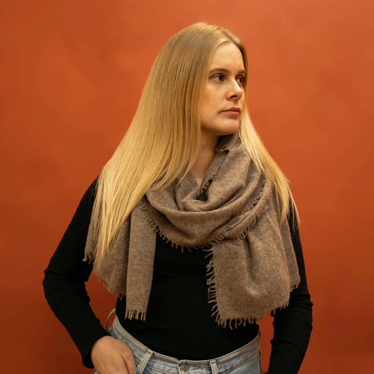  Woman wearing oversized taupe brown woven cashmere shawl wrapped around neck — Griha pure Himalayan cashmere