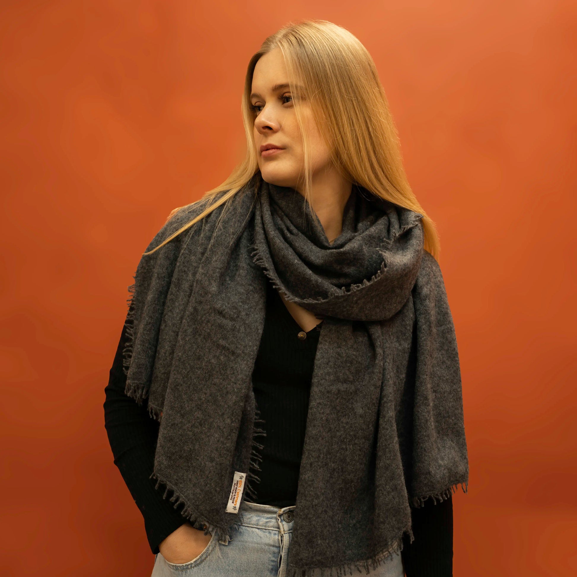 Woman wearing oversized charcoal woven cashmere shawl wrapped around neck — Griha pure Himalayan cashmere