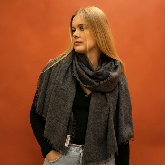Woman wearing oversized charcoal woven cashmere shawl wrapped around neck — Griha pure Himalayan cashmere