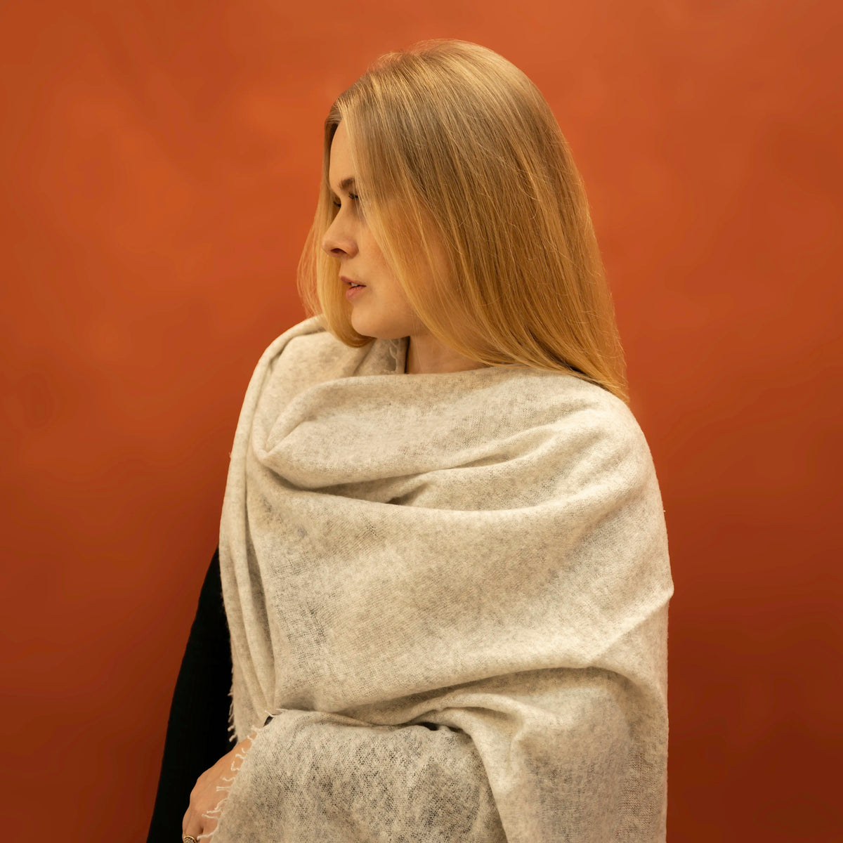 Woman wearing oversized light grey pure cashmere woven shawl draped over shoulders — Griha Himalayan cashmere