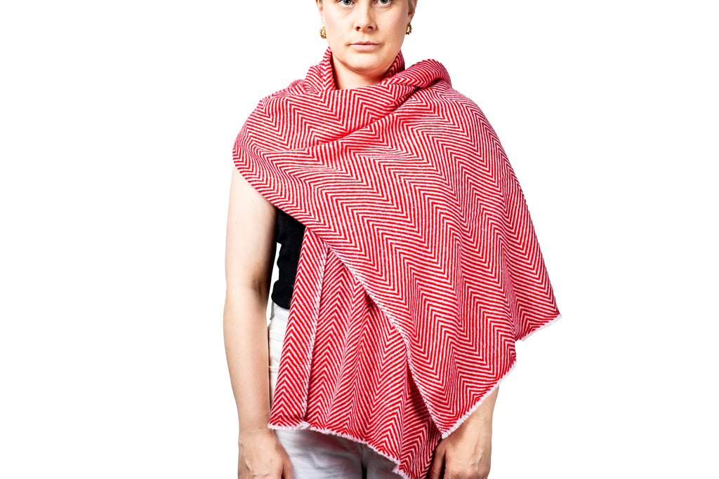 Person wearing a red and white patterned pashmina shawl on a white background- GRIHA