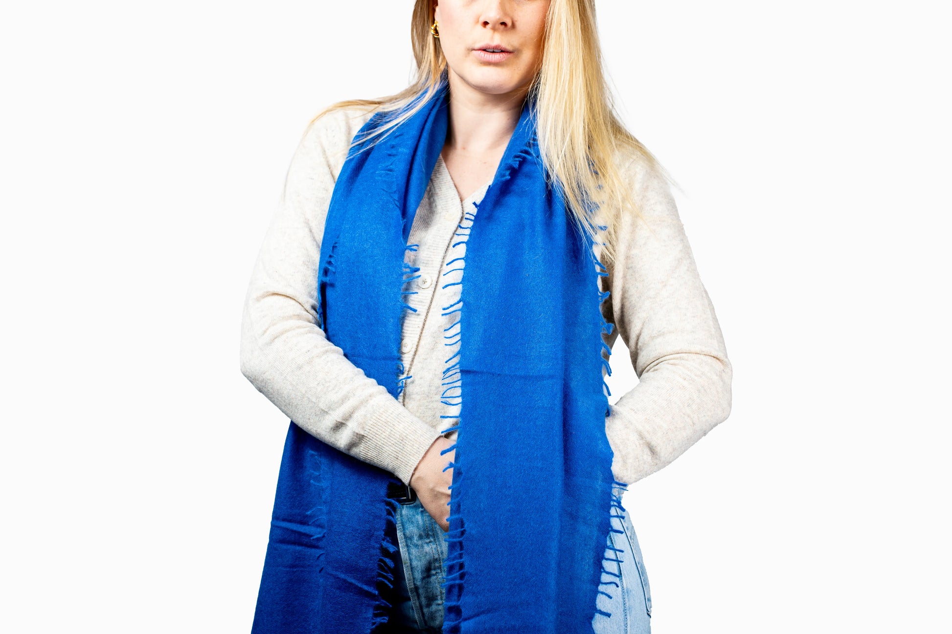 Woman wearing a blue cashmere scarf with a white background GRIHA