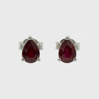 Natural Ruby Triangle Shaped Stud Earrings set in high quality sterling silver on a white background.