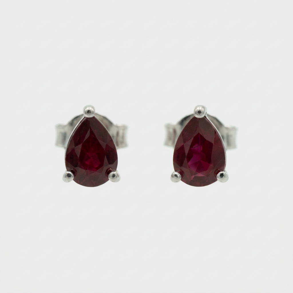 Natural Ruby Triangle Shaped Stud Earrings set in high quality sterling silver on a white background.