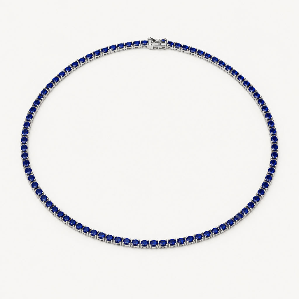 A tennis necklace featuring dark blue square-cut stones set in silver-toned metal, arranged in a circle on a plain white background.
