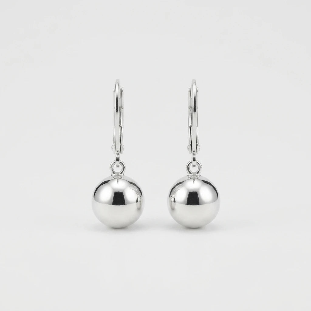 A pair of polished silver leverback earrings with smooth, spherical drop charms, shown against a clean, light gray background.