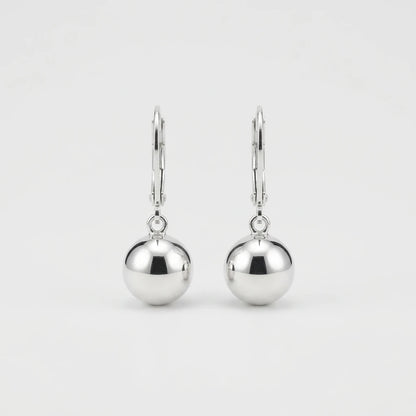 A pair of polished silver leverback earrings with smooth, spherical drop charms, shown against a clean, light gray background.