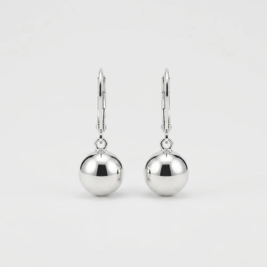 A pair of polished silver leverback earrings with smooth, spherical drop charms, shown against a clean, light gray background.
