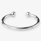 Silver bangle with spherical ends on a white background