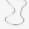 A silver snake chain necklace with small, evenly spaced spherical bead accents, displayed on a clean white background.