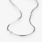 A silver snake chain necklace with small, evenly spaced spherical bead accents, displayed on a clean white background.