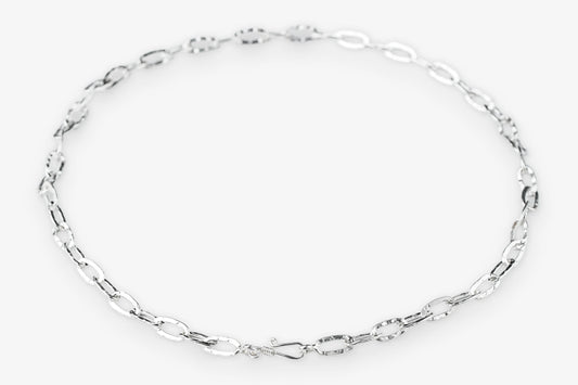 Silver paperclip chain necklace on a white background
