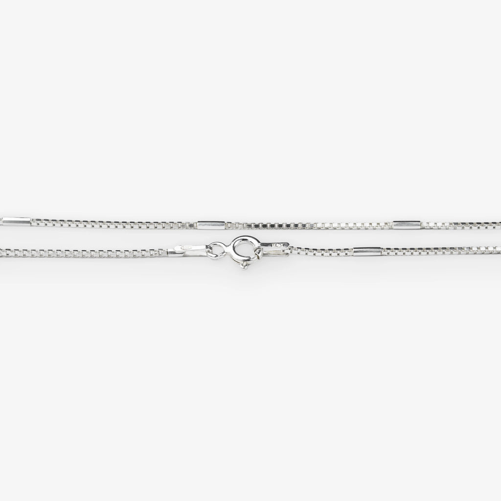 A silver-toned chain necklace with a lobster clasp, shown horizontally against a plain white background.