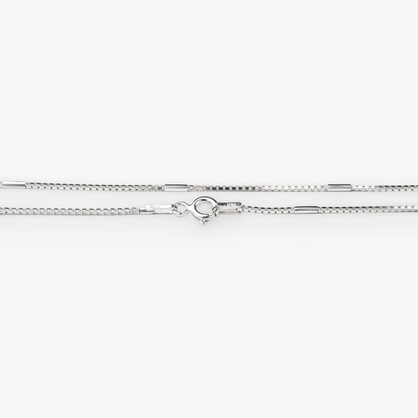A silver-toned chain necklace with a lobster clasp, shown horizontally against a plain white background.