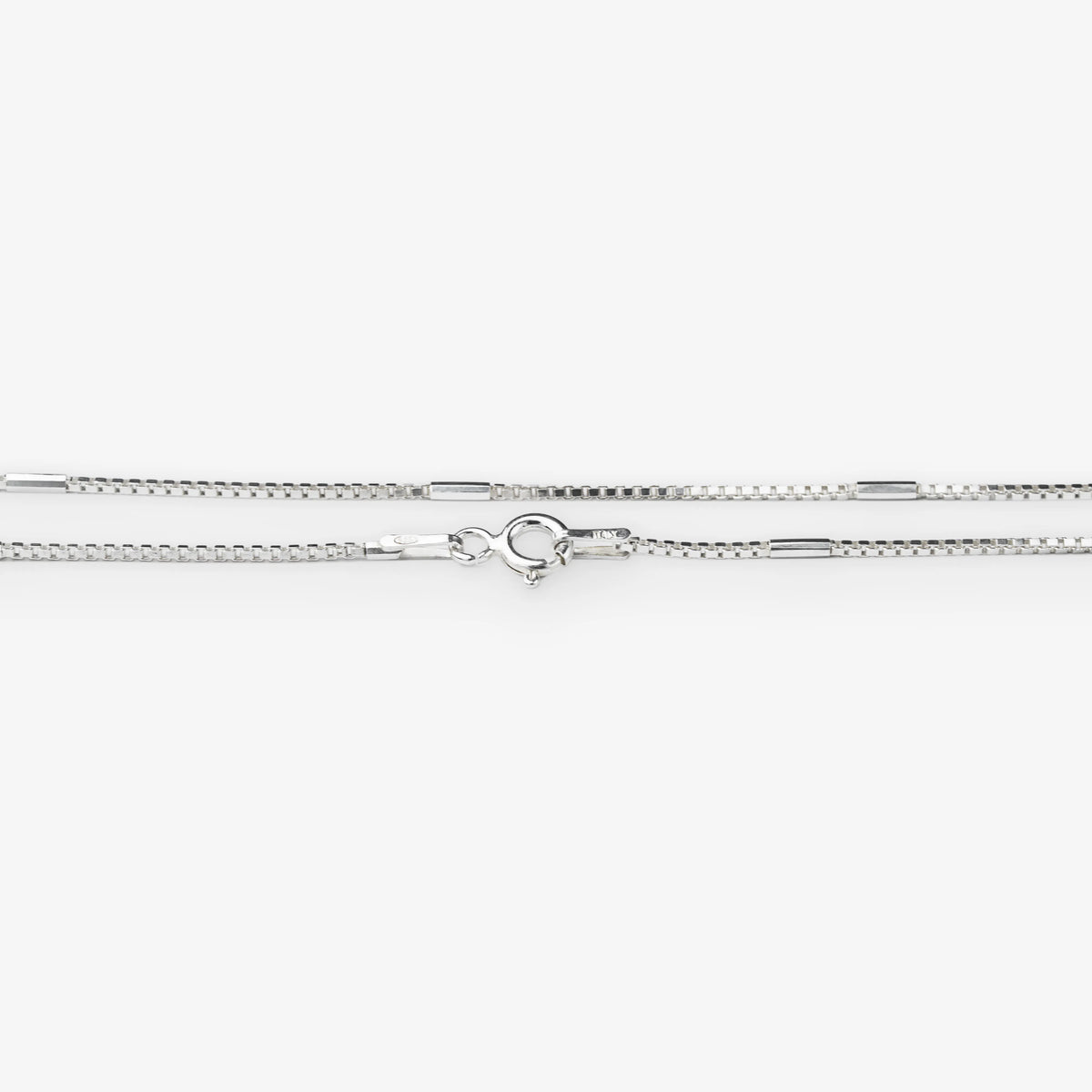 A silver-toned chain necklace with a lobster clasp, shown horizontally against a plain white background.