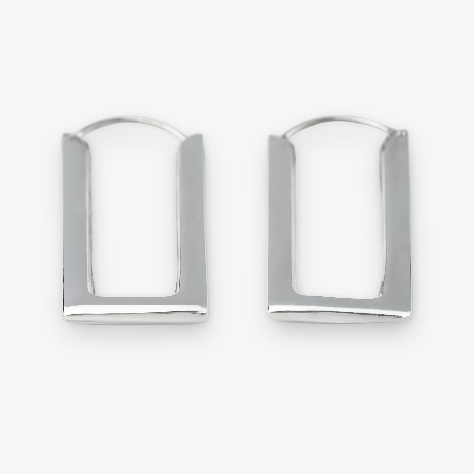 A pair of sterling silver geometric hoop earrings with a modern, open rectangular arch design, displayed on a clean white background.