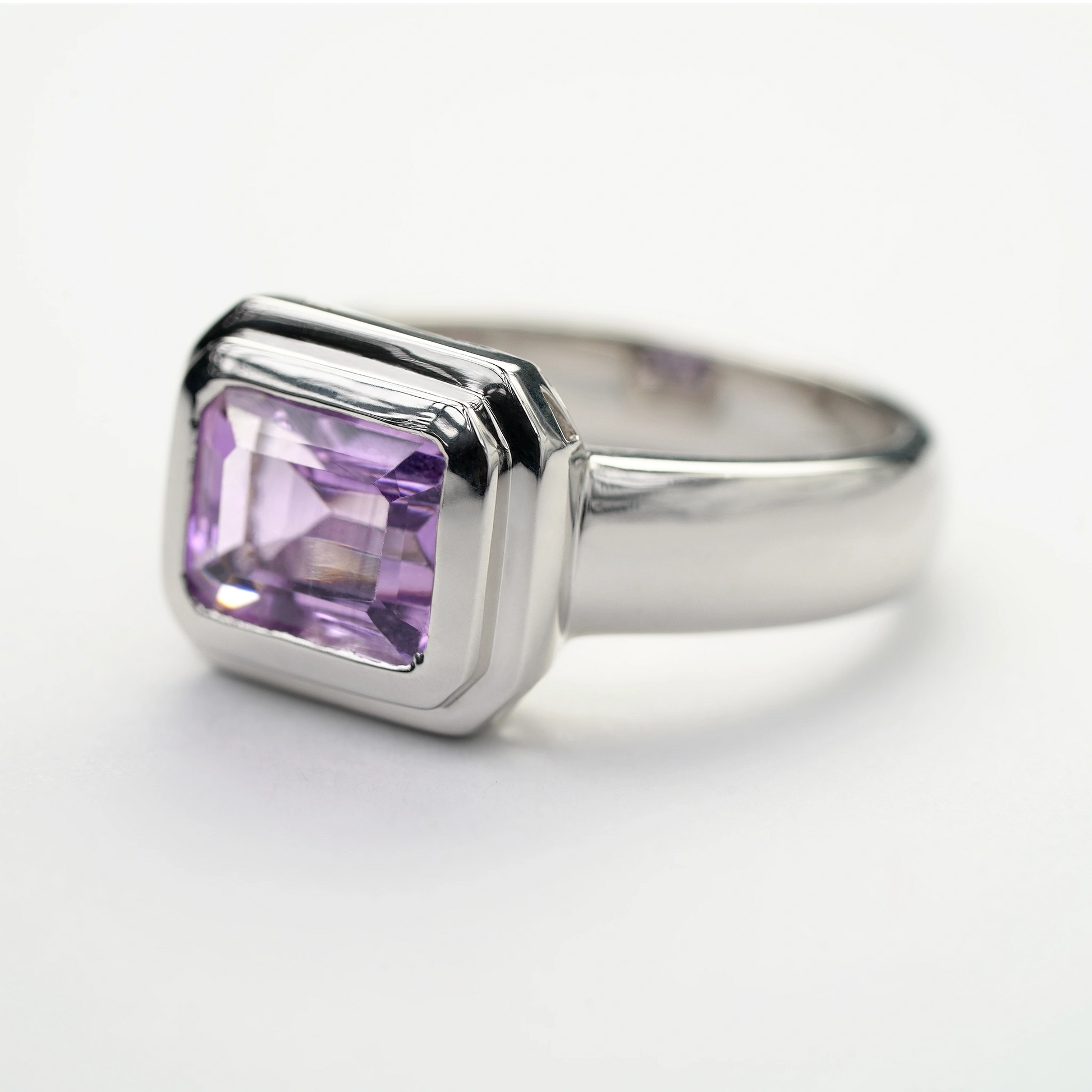 Sterling silver amethyst gemstone ring with a rectangular-cut purple stone in a modern bezel setting