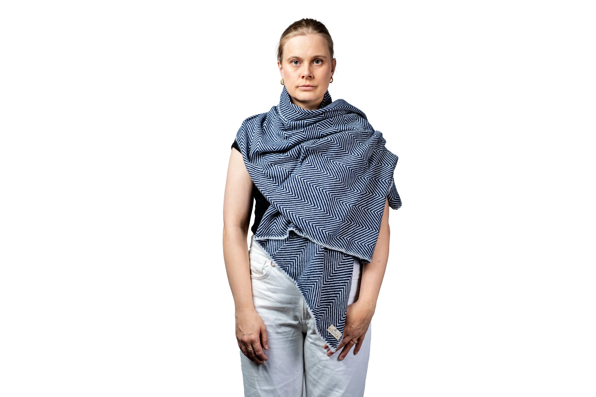 Woman wearing a blue patterned shawl on a white background