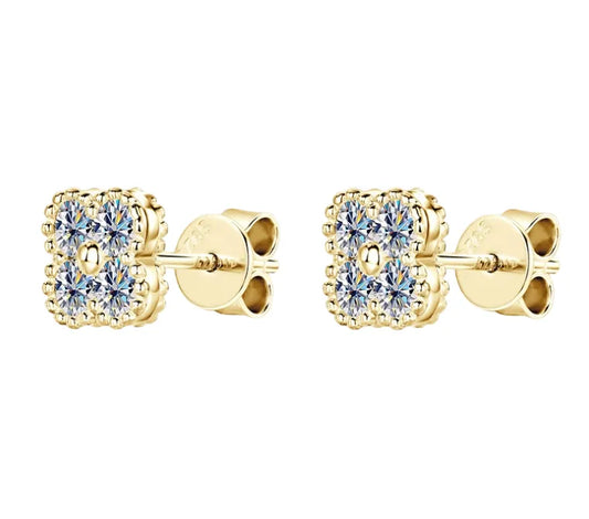 Gold stud clover earrings with clear moissanite gemstones on a white background